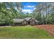 Charming brick home with arched windows, mature landscaping, and a well-maintained lawn at 2095 Woodberry Dr, Clayton, NC 27527