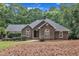 Charming brick home with arched windows, mature landscaping, and a welcoming front entrance at 2095 Woodberry Dr, Clayton, NC 27527