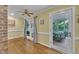 Sunny sunroom with hardwood floors, neutral paint, and access to screened in porch at 2095 Woodberry Dr, Clayton, NC 27527