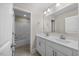 Bathroom featuring dual sinks, a vanity, tile floors, and a walk-in shower at 2223 Copper Pond Way, Fuquay Varina, NC 27526