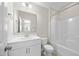 Bathroom featuring a single sink vanity with large mirror and a shower and bathtub combo at 2223 Copper Pond Way, Fuquay Varina, NC 27526