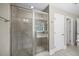 Glass enclosed shower featuring natural stone tile, shower niche, and a showerhead at 2223 Copper Pond Way, Fuquay Varina, NC 27526