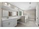 Bathroom featuring a double sink vanity, a large mirror, and a glass shower with a tub at 2223 Copper Pond Way, Fuquay Varina, NC 27526
