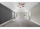Large bedroom featuring a tray ceiling, a ceiling fan, multiple windows, and neutral paint at 2223 Copper Pond Way, Fuquay Varina, NC 27526