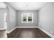 Neutral dining room featuring dark wood floors, and a modern light fixture at 2223 Copper Pond Way, Fuquay Varina, NC 27526