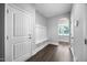 Entryway with coat rack, storage and white craftsman-style door with grey walls at 2223 Copper Pond Way, Fuquay Varina, NC 27526