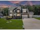 Beautiful two-story home with a manicured lawn and three-car garage at 2223 Copper Pond Way, Fuquay Varina, NC 27526