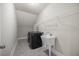 Well-equipped laundry room featuring a washer, dryer, utility sink, and plenty of storage on metal shelving at 2223 Copper Pond Way, Fuquay Varina, NC 27526