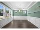 Sunlit room featuring elegant trim detail, a modern chandelier, and large windows at 2223 Copper Pond Way, Fuquay Varina, NC 27526