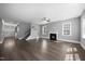 Open living space boasting a fireplace, staircase, and views into the foyer at 2223 Copper Pond Way, Fuquay Varina, NC 27526