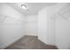 Spacious walk-in closet features neutral paint and metal shelving for clothing and shoes at 2223 Copper Pond Way, Fuquay Varina, NC 27526