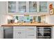 Home bar featuring glass cabinets, a wine fridge, modern appliances, and stylish décor at 227 W Drewry Ln, Raleigh, NC 27609