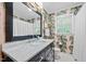 Bathroom features a modern sink, elegant wallpaper, and plenty of natural light at 227 W Drewry Ln, Raleigh, NC 27609