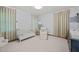 Bright Bedroom features a crib, rocking chair, soft carpet, and charming decor at 227 W Drewry Ln, Raleigh, NC 27609