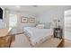 Cozy bedroom with light blue walls, white trim, and bright natural light streaming through window at 227 W Drewry Ln, Raleigh, NC 27609
