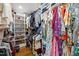 Walk-in closet featuring custom shelves for shoe storage and ample hanging space at 227 W Drewry Ln, Raleigh, NC 27609