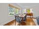 Sunlit dining room featuring hardwood floors, a large window with blinds, and a traditional dining set at 227 W Drewry Ln, Raleigh, NC 27609