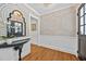Elegant foyer with patterned wallpaper, a stylish mirror, and hardwood flooring creating a welcoming entrance at 227 W Drewry Ln, Raleigh, NC 27609