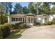 Beautiful exterior of a white brick home showcasing well-maintained landscaping and a concrete driveway at 227 W Drewry Ln, Raleigh, NC 27609