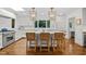 Bright kitchen features a large island with seating, custom cabinets, and stainless steel appliances at 227 W Drewry Ln, Raleigh, NC 27609