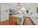 Open kitchen features a large island with seating, modern appliances, and access to the living room at 227 W Drewry Ln, Raleigh, NC 27609