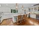 Bright kitchen features a large island with seating, custom cabinets, and stylish gold pendant lighting at 227 W Drewry Ln, Raleigh, NC 27609