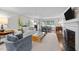 Cozy living room with a fireplace, hardwood floors, and stylish furnishings creating a comfortable and inviting space at 227 W Drewry Ln, Raleigh, NC 27609