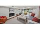 Basement living room features a white-painted brick fireplace, comfortable seating, and lots of light at 227 W Drewry Ln, Raleigh, NC 27609