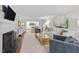 Open-concept living room showcasing hardwood floors, a fireplace, and seamless flow into the kitchen and dining areas at 227 W Drewry Ln, Raleigh, NC 27609