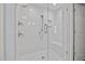 Modern glass shower featuring a white tiled interior, multiple shower heads, and built-in seat at 227 W Drewry Ln, Raleigh, NC 27609