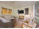 Cozy sunroom features wicker seating, a ceiling fan, and large windows for enjoying the outdoors at 227 W Drewry Ln, Raleigh, NC 27609