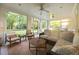 Sunroom with lots of windows overlooking the backyard, comfortable seating and ceiling fans at 227 W Drewry Ln, Raleigh, NC 27609