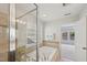 Bright bathroom featuring tiled shower, soaking tub, and transom window at 2323 Pindos Dr, Cary, NC 27519