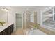 Bright bathroom featuring double vanity, tiled shower, soaking tub and walk-in closet at 2323 Pindos Dr, Cary, NC 27519