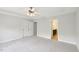 Spacious bedroom with plush carpeting and entry to the bathroom and closets at 2323 Pindos Dr, Cary, NC 27519