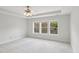 Sunlit bedroom featuring plush carpet, a ceiling fan, and three large windows at 2323 Pindos Dr, Cary, NC 27519