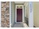 Charming home entrance features a red front door and stone accents at 2323 Pindos Dr, Cary, NC 27519