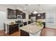 Well-equipped kitchen with stainless steel appliances, granite counters, and rich dark cabinets at 2323 Pindos Dr, Cary, NC 27519