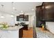 Bright kitchen featuring an island with a sink, stainless steel appliances and granite countertops at 2323 Pindos Dr, Cary, NC 27519