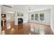 Open living room with a fireplace and hardwood flooring at 2323 Pindos Dr, Cary, NC 27519