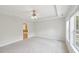 Bright bedroom with tray ceiling and carpeted floors. Adjoining bathroom at 2323 Pindos Dr, Cary, NC 27519