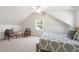 Bright bedroom with carpeted floors, slanted ceilings, and modern furnishings at 2707 Anderson Dr, Raleigh, NC 27608