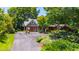 Charming home with stone accents, lush landscaping, and a spacious driveway at 2707 Anderson Dr, Raleigh, NC 27608