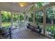 Screened porch with hardwood flooring and plenty of natural light at 2707 Anderson Dr, Raleigh, NC 27608