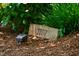 A natural stone address marker with the number '2707' engraved, surrounded by lush greenery and mulch at 2707 Anderson Drive Dr, Raleigh, NC 27608