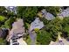 An aerial view of a home with a gray roof, surrounded by lush greenery in a neighborhood setting at 2707 Anderson Drive Dr, Raleigh, NC 27608