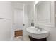 Powder room featuring a white vanity, elegant fixtures, and a neutral color palette at 2707 Anderson Drive Dr, Raleigh, NC 27608