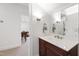 Stylish bathroom vanity with dark wood, marble countertop, and a mirror, creating a functional and elegant space at 2707 Anderson Drive Dr, Raleigh, NC 27608