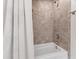 Bright bathroom featuring a tiled shower-tub, a white shower curtain and silver fixtures at 2707 Anderson Drive Dr, Raleigh, NC 27608