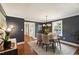 Stylish dining room with navy walls, a modern chandelier, and seating for four at 2707 Anderson Drive Dr, Raleigh, NC 27608